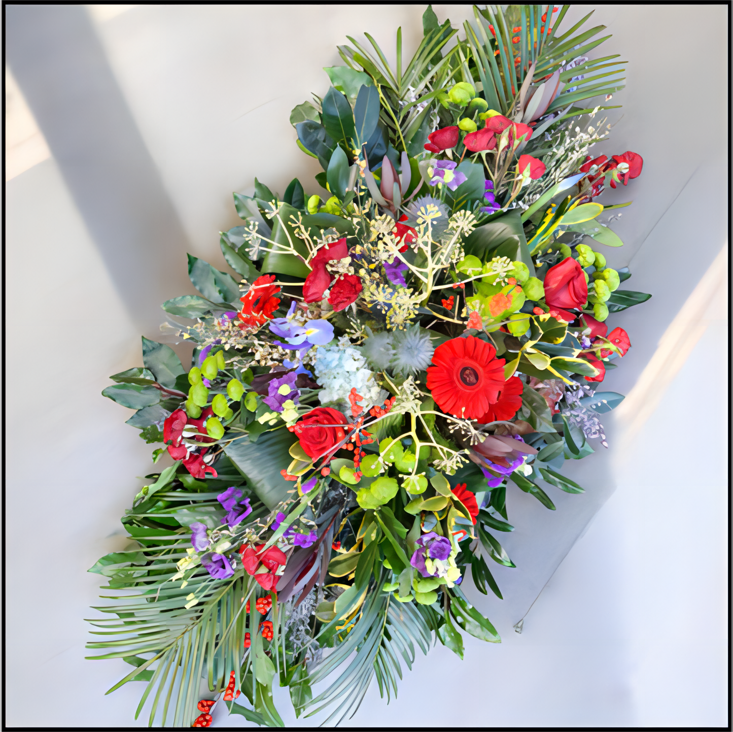 Colourful floral Spray with red, green, and purple flowers