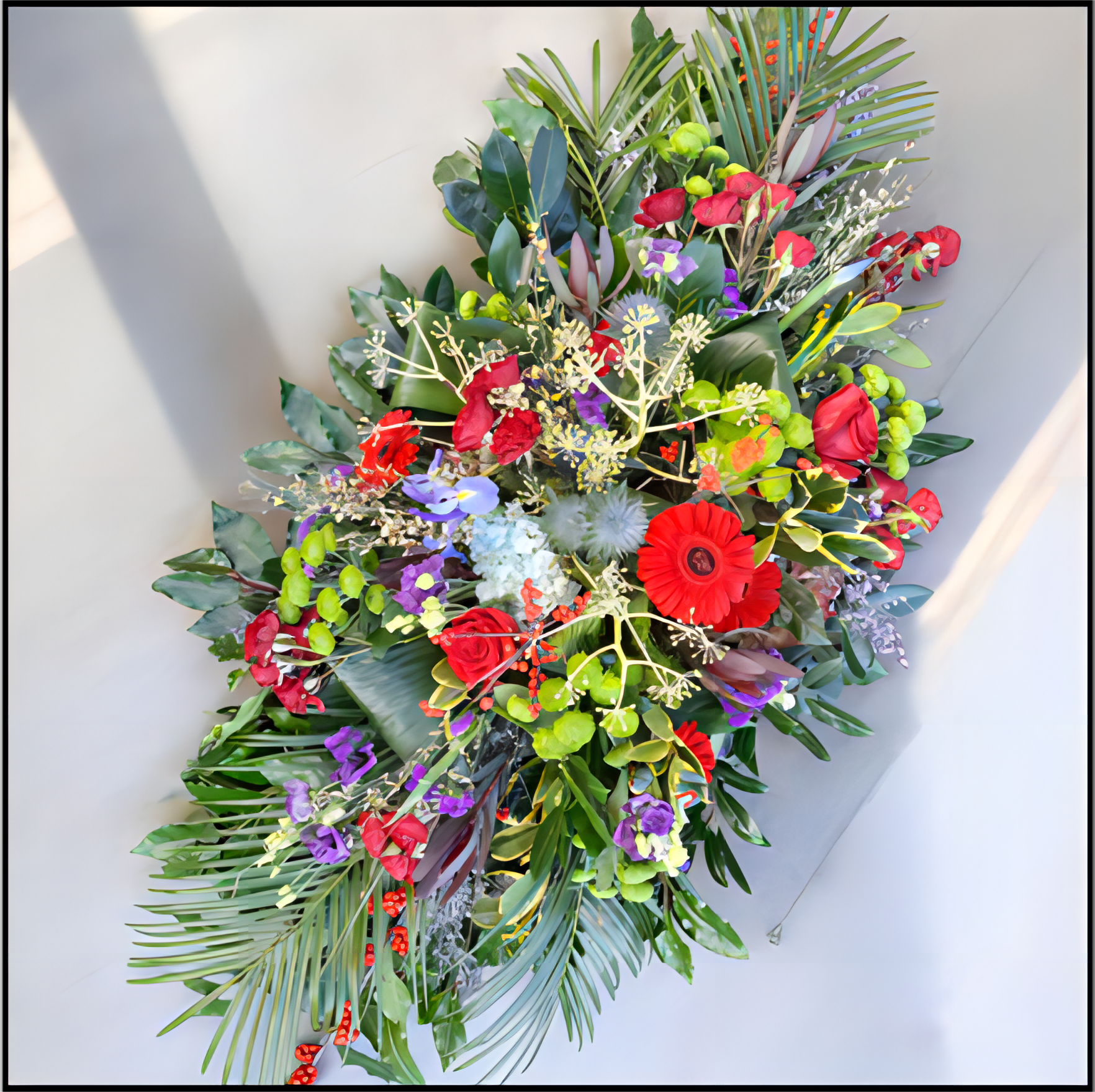 Colourful floral Spray with red, green, and purple flowers