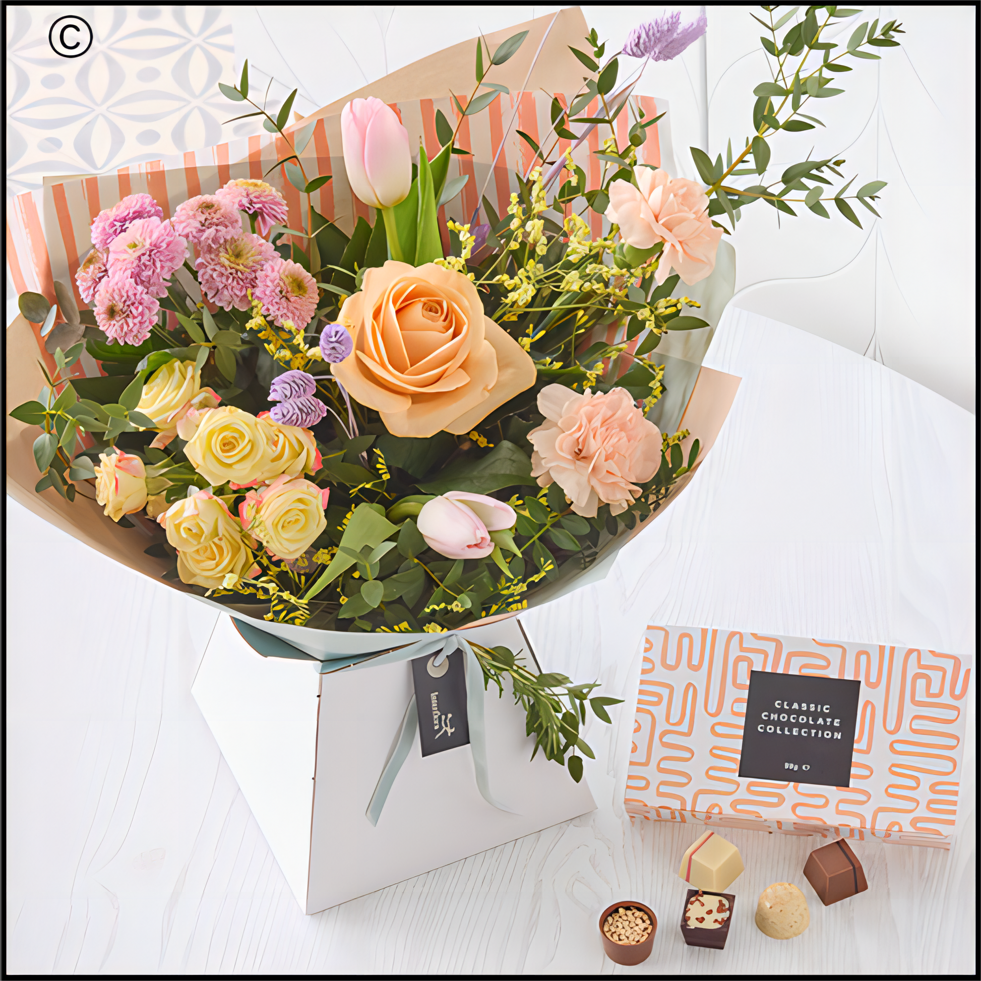 Bouquet of flowers with a box of chocolates.