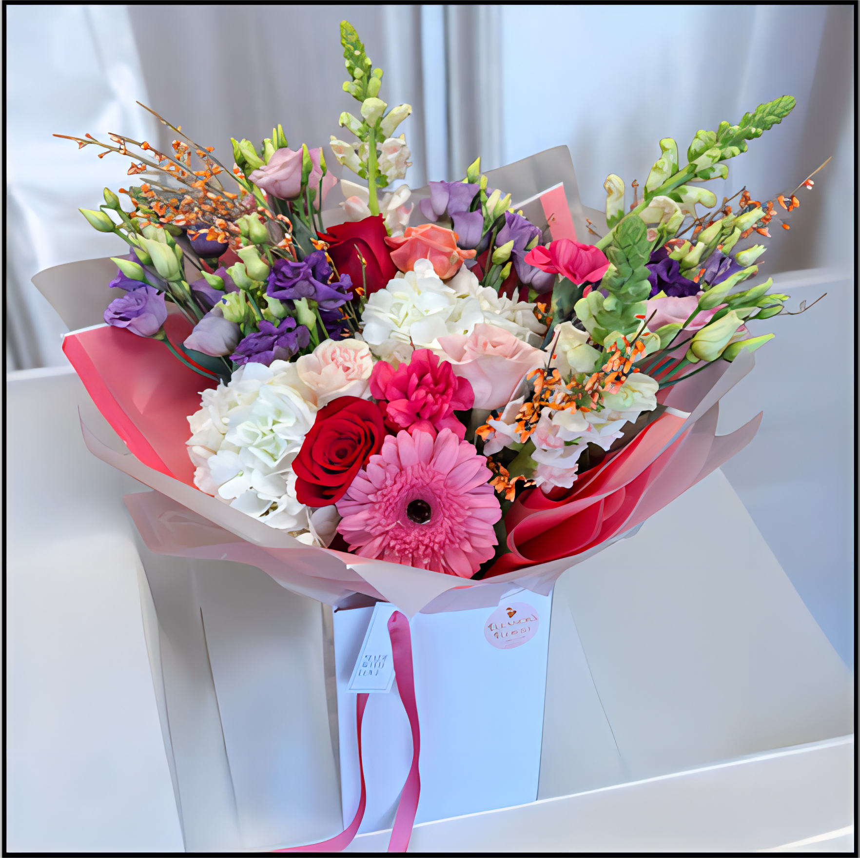 Bouquet of colourful flowers in a box 